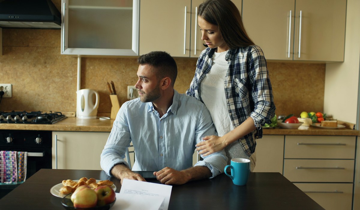 Couple talking at a kitchen table