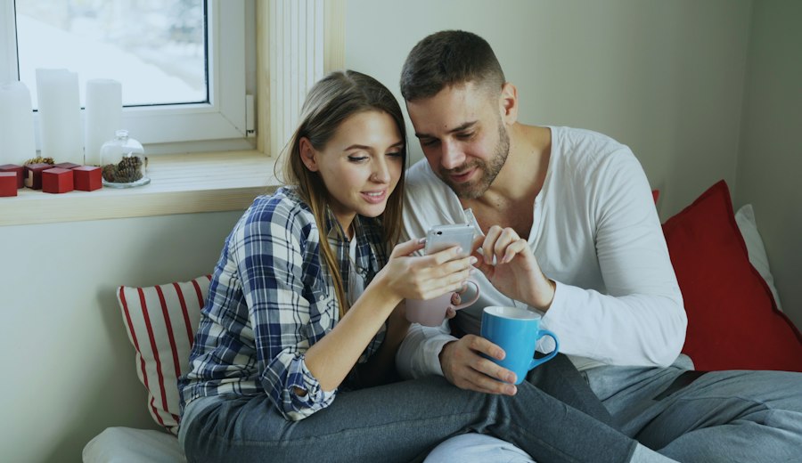 Couple checking their savings on a phone