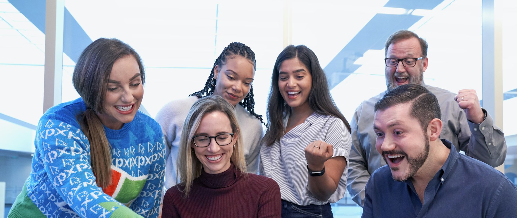Team gathered around a table in a bright office