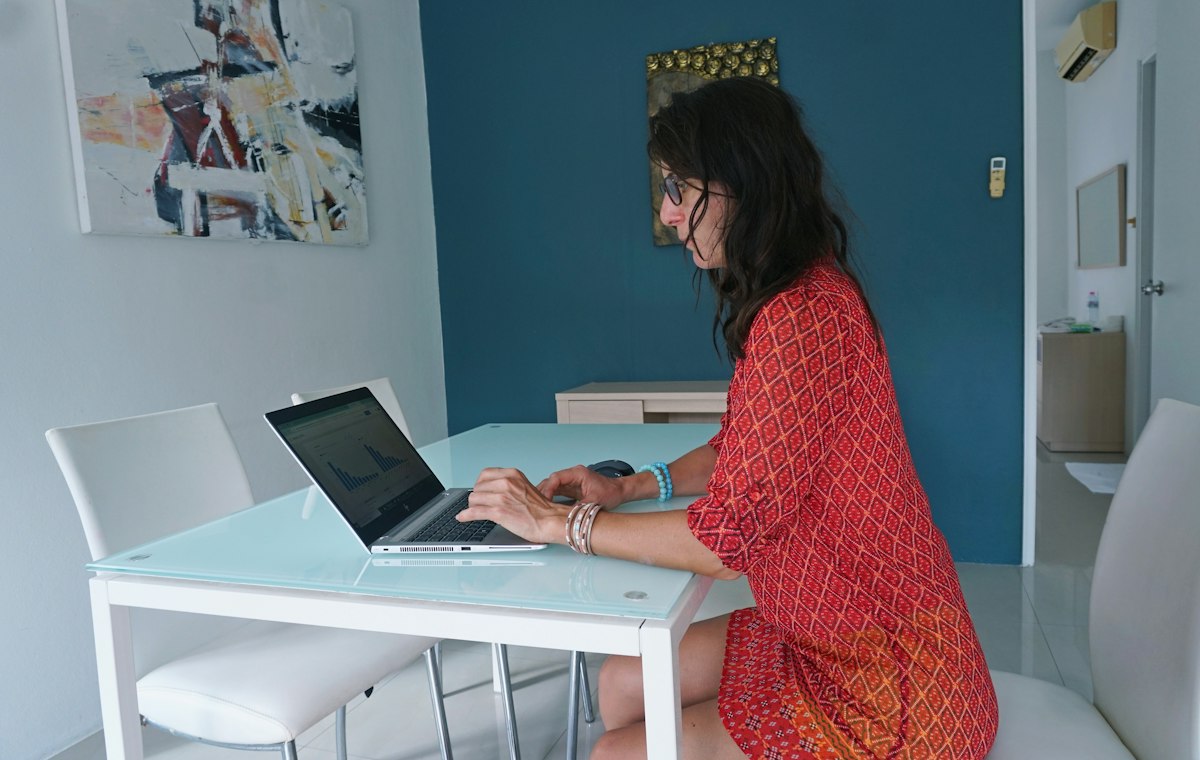 Broker working on a laptop at a table